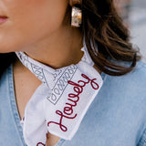 Lifestyle shot of white/maroon howdy frilly . The maroon howdy portion is embroidered.