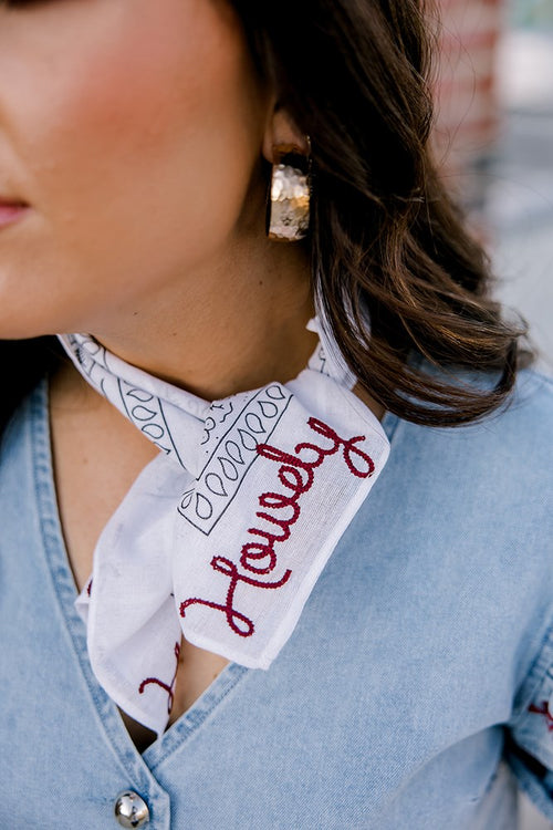 Lifestyle shot of white/maroon howdy frilly . The maroon howdy portion is embroidered.