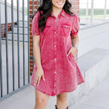 Woman with dark hair wearing a short-sleeve maroon denim midi dress.