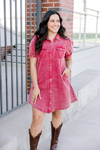 Woman with dark hair wearing a short-sleeve maroon denim midi dress.