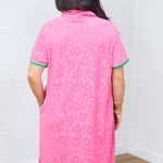 Woman with dark hair standing in a back profile position wearing the Cami Dress against a white background. The focal point of this image is the leopard fabric in pink as well as striping along cuff. 