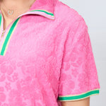 Woman with dark hair standing in a front profile position wearing the Cami Dress against a white background. The focal point of this image is an in-depth view of fabric print as well as a sneak-peak of the quarter zip on front of dress.