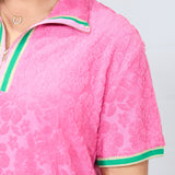 Woman with dark hair standing in a front profile position wearing the Cami Dress against a white background. The focal point of this image is an in-depth view of fabric print as well as a sneak-peak of the quarter zip on front of dress.