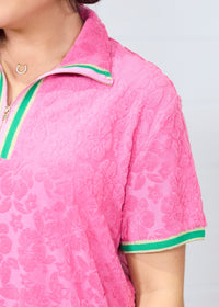 Woman with dark hair standing in a front profile position wearing the Cami Dress against a white background. The focal point of this image is an in-depth view of fabric print as well as a sneak-peak of the quarter zip on front of dress.