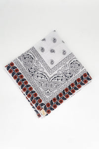 Zoomed out image of the burnt orange floral frilly. Floral pattern is embroidered. 
