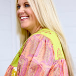 Woman with blonde hair showing side profile and sleeve detail of Jeanie Top. 