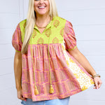 Woman with blonde hair standing in a front profile against white background. She paired the Jeanie Top with a denim skirt. 