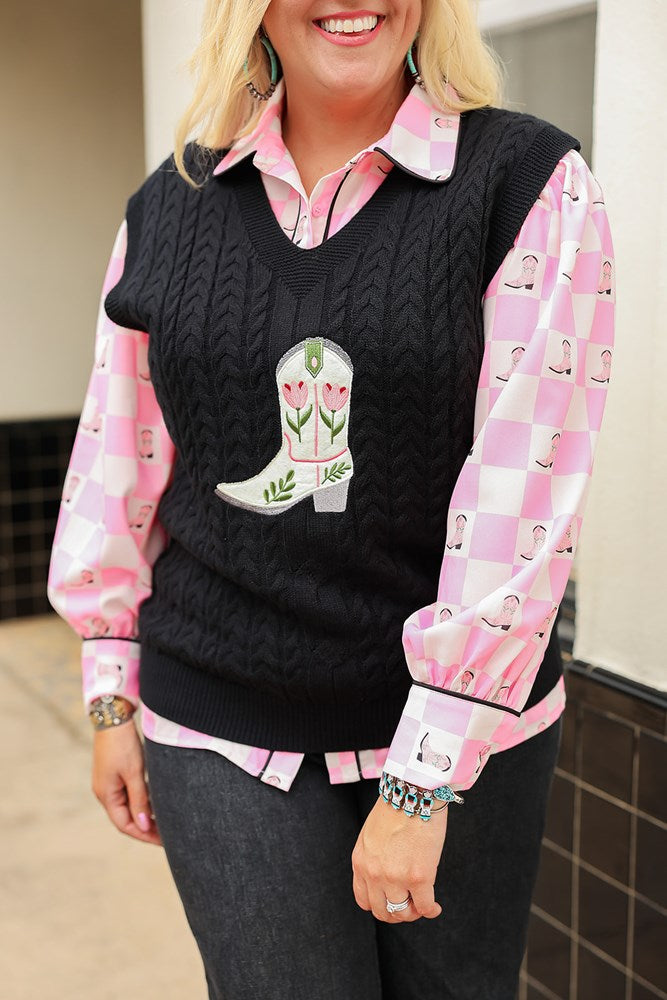 Woman with blonde hair standing in a front profile position wearing the Kodi Vest in a lifestyle scene. The focal point of this image is the embroidered boot on front of top. The model paired this with dark-wash denim jeans and the Jesse Top.