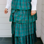 Woman wearing a green/red plaid maxi ruffle skirt with the Renee Top-White. 