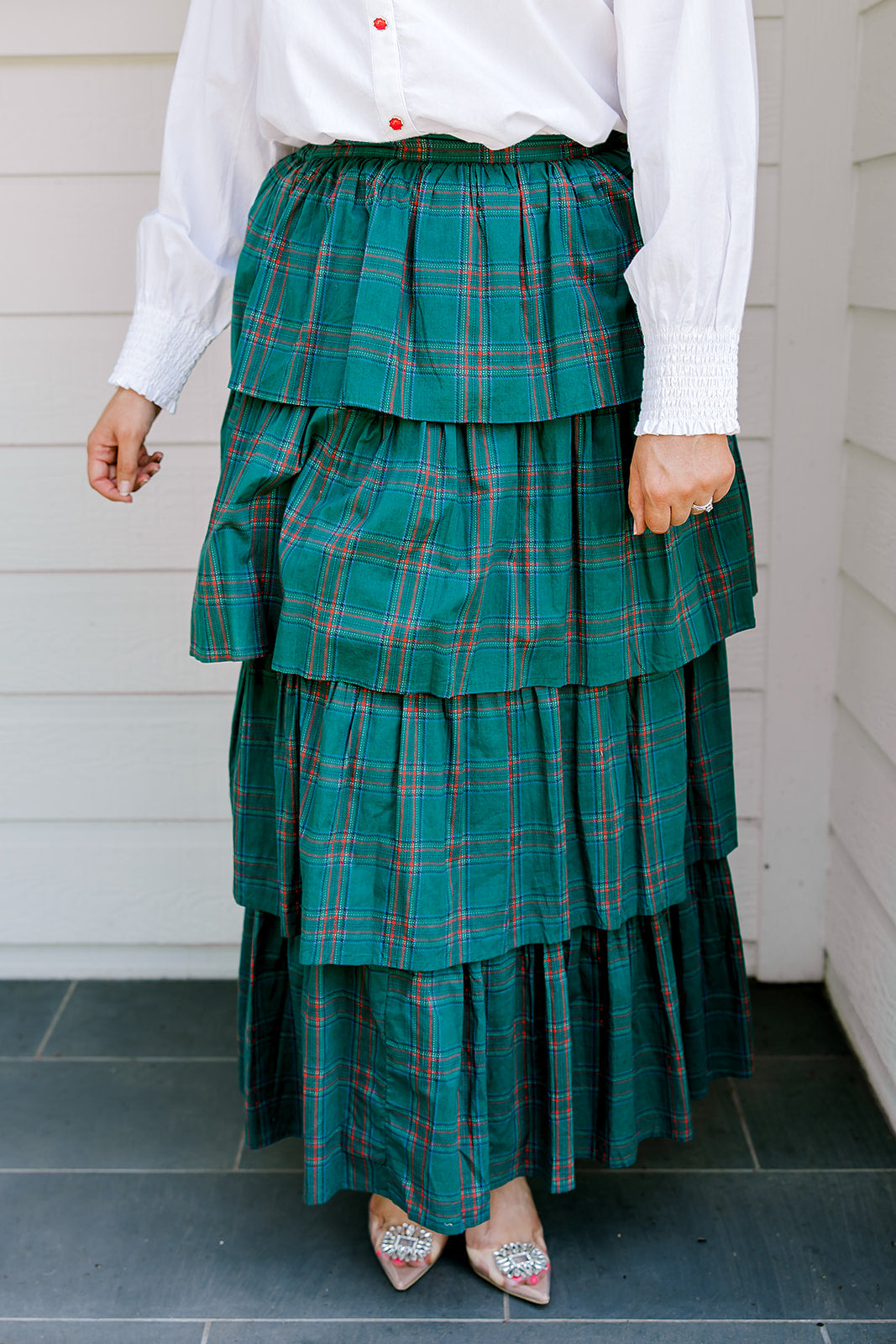 Woman wearing a green/red plaid maxi ruffle skirt with the Renee Top-White. 