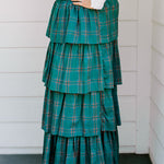 Woman wearing a green/red plaid maxi ruffle skirt with the Renee Top-White. 