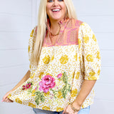 Woman with blonde hair in front facing position against a white background wearing the Tinley Top. She has top paired with light-wash denim shorts. 