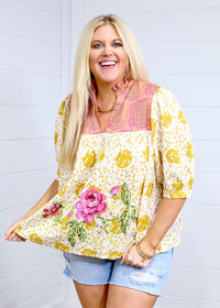 Woman with blonde hair in front facing position against a white background wearing the Tinley Top. She has top paired with light-wash denim shorts. 
