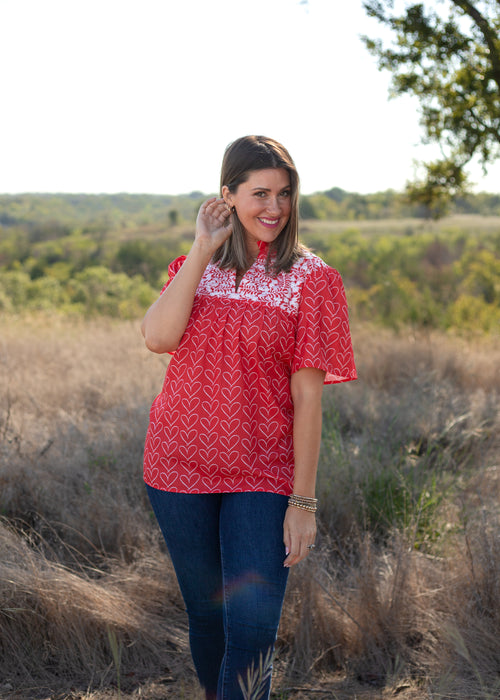 Front Honey Top red heart print top with embroidery.